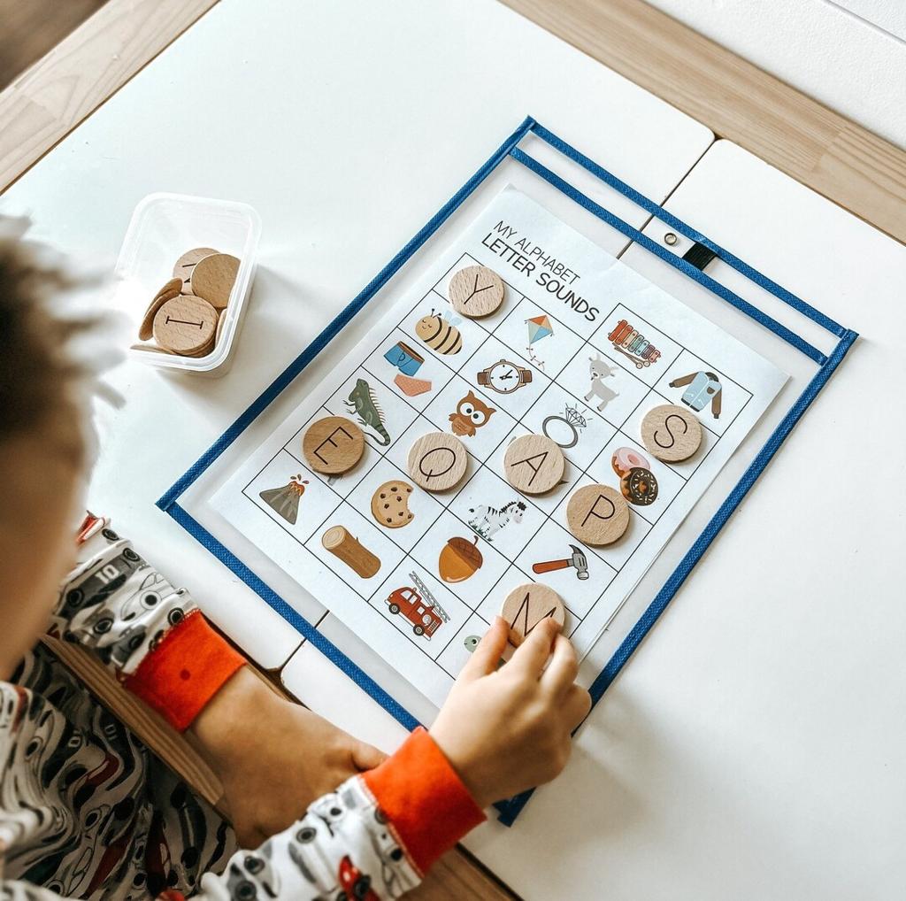 A child matching wooden letters during a sound-awareness activity